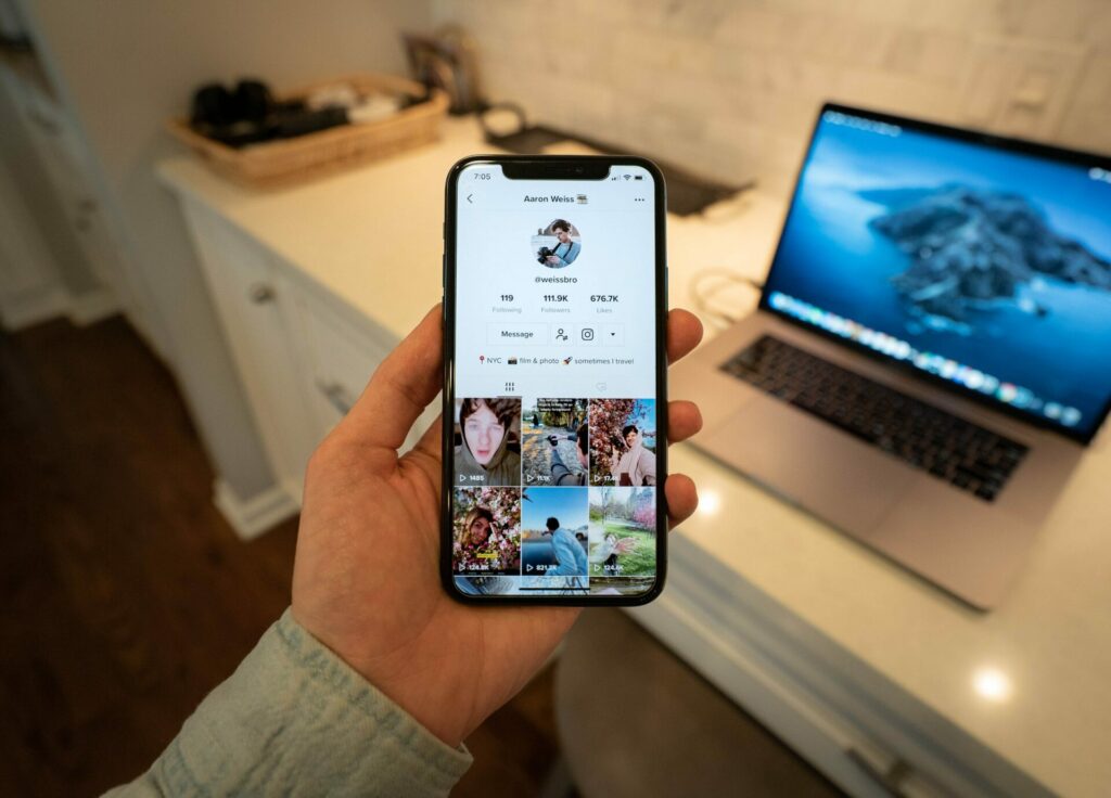 TikTok feed showing on smartphone screen held by hand Stellar - Image from Unsplash